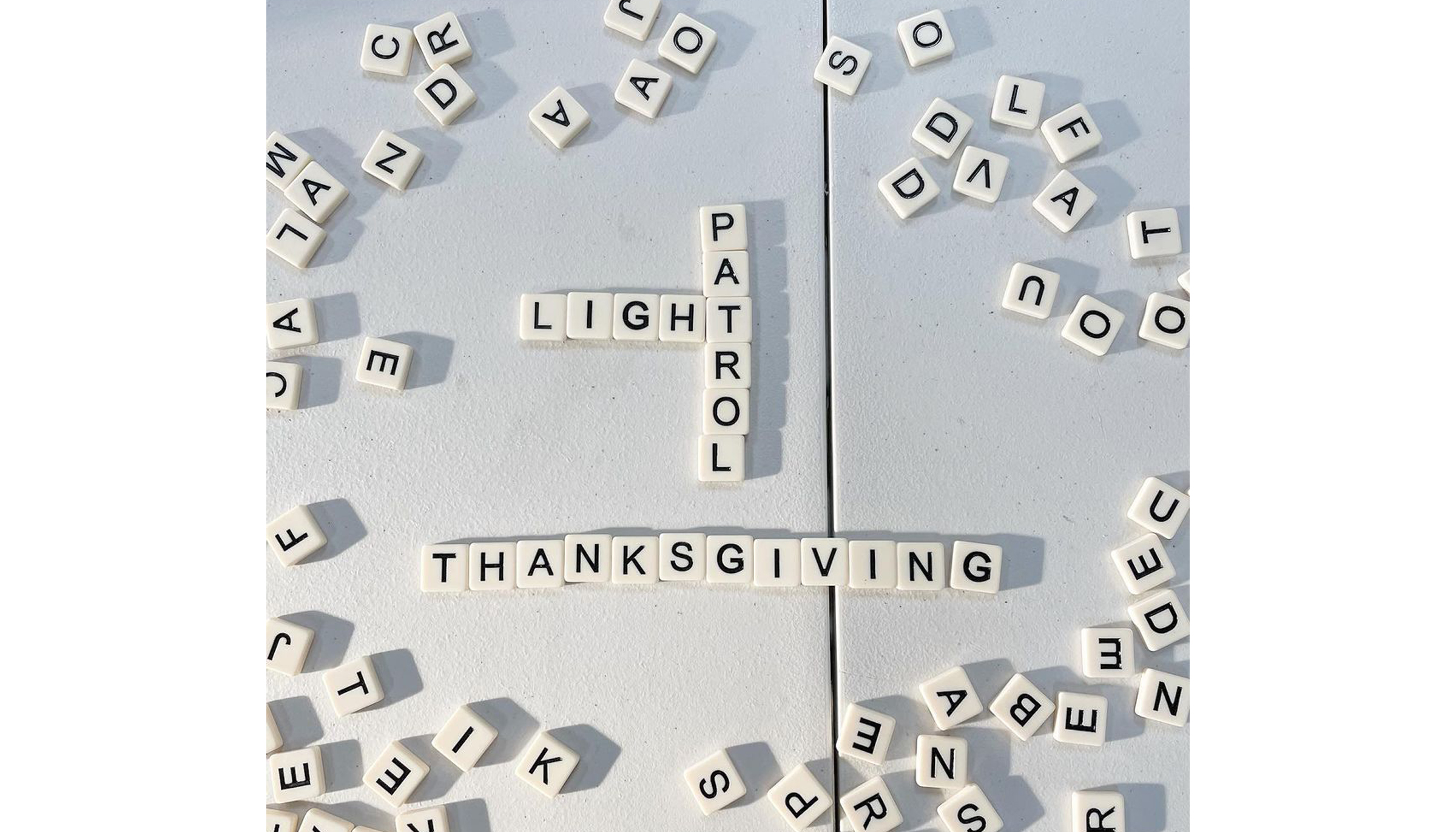 Scrabble game with words Light Partol and Thanksgiving